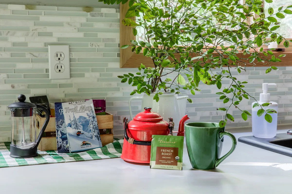The kitchen counter — a French press and the area trail map